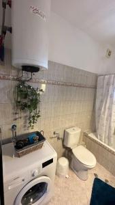 a small bathroom with a toilet and a sink at Proluxe Apartments in Alexandroupoli