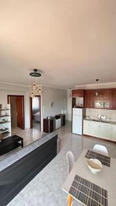 a living room and kitchen with a couch and a table at Proluxe Apartments in Alexandroupoli