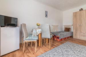 a living room with a table and chairs and a bed at Privát Marika in Ždiar