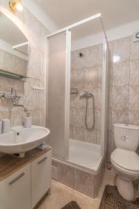 a bathroom with a shower and a toilet and a sink at Privát Marika in Ždiar +21 photos