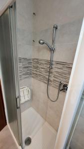a shower with a glass door in a bathroom at Casa Paola - Appartamento 2 stanze a Recoaro Terme in Recoaro Terme +13 photos