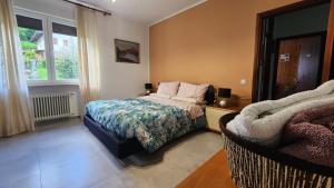 a bedroom with a bed and a window at Casa Paola - Appartamento 2 stanze a Recoaro Terme in Recoaro Terme