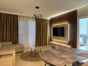 a living room with a couch and a table at Prive Luxury Apartments -City Center & Seaside in 1 in Vlorë