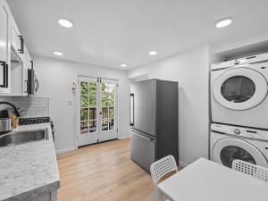 a kitchen with a refrigerator and a table with chairs at Shadyside, Central 3C Spacious & Modern Private Bedroom With Shared Bathroom and Free Parking in Pittsburgh