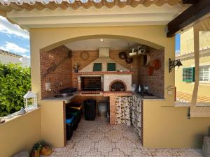 an outdoor kitchen with a brick wall and a counter at Happy Silva Guesthouse in Lagos