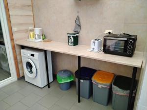 a kitchen with a counter with a microwave and a washing machine at Apartmani Marijan in Crikvenica +22 photos