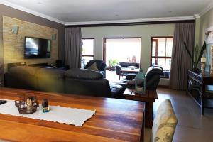 a living room with a couch and a table at Marks Cottages in Durban
