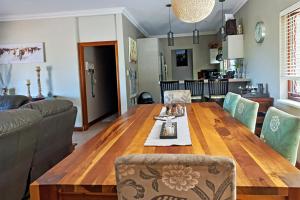 a living room with a wooden table and a couch at Marks Cottages in Durban