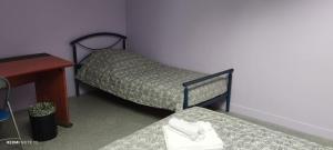 a small room with two beds and a desk at Appartement indépendant chez l'habitant in Cholet