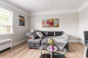 a living room with a couch and a table at 1BR Modern Apt - Corktown Hamilton in Hamilton