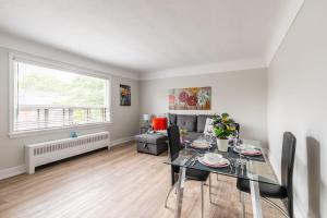 a living room with a table and a couch at 1BR Modern Apt - Corktown Hamilton in Hamilton +9 photos