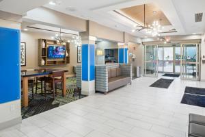 a large lobby with a desk and a television at Holiday Inn Express and Suites Stroudsburg-Poconos, an IHG Hotel in Stroudsburg
