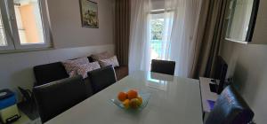 a room with a table with a bowl of fruit on it at Villa Stegic in Tisno