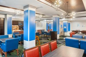 a view of a dining room with blue chairs and tables at Holiday Inn Express and Suites Stroudsburg-Poconos, an IHG Hotel in Stroudsburg