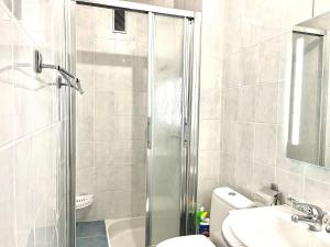 a bathroom with a shower and a toilet and a sink at M037 Marquer Joli T2 in Ambilly