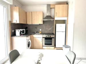 a kitchen with wooden cabinets and a stove top oven at M037 Marquer Joli T2 in Ambilly