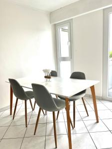 a dining room with a white table and chairs at M037 Marquer Joli T2 in Ambilly