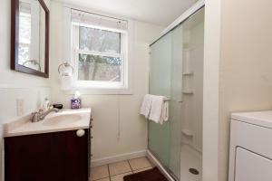 a bathroom with a sink and a shower at Downtown Cottage in Durango +14 photos