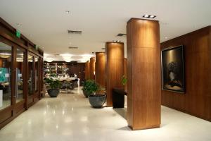 a lobby with wooden walls and potted plants at Hotel Metropolitano Supara in Buenos Aires