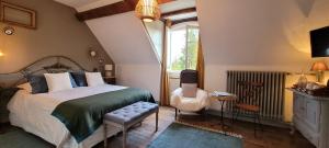 a bedroom with a bed and a chair and a window at Moulin de Giboudet Chambres d'hôtes in Bazainville +83 photos