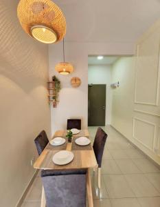 a dining room with a wooden table and chairs at 2 bedroom apartment 5 people in Nilai