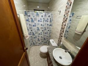 a bathroom with a sink and a toilet and a shower at Casa Boutique Rincon in San Onofre