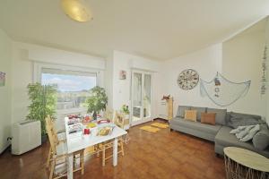 a living room with a couch and a table at Petronella - Gardagate in Soiano del Lago
