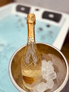 a bottle of champagne in a bucket of ice at Kinnaird Woodland Lodges in Pitlochry