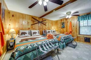 a bedroom with two beds and a ceiling fan at Pet-Friendly Creekside Cabin with Pool Access! in Maggie Valley +29 photos