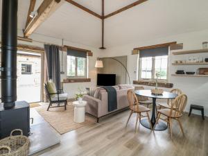 a living room with a couch and a table at Ash Cottage - Fold Yards in Belper