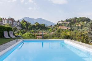 a swimming pool with a view of a mountain at Bellagio Beautiful Oasi in Bellagio