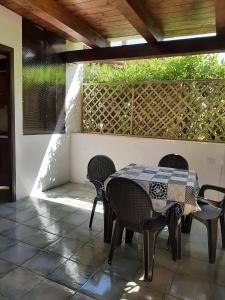 a patio with a table and chairs and a fence at Residence Eden in Marina di Camerota