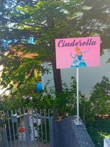a sign in front of a fence with a disney sign at Guest House Cinderella in Herceg-Novi