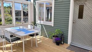 eine Terrasse mit einem Tisch und Stühlen auf einer Terrasse in der Unterkunft Mysig stuga i Svärtinge in Svärtinge