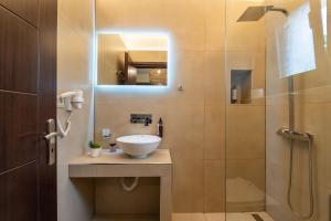 a bathroom with a sink and a shower at Aiora Suites in Sivota