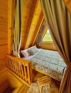 a bedroom with a bed in a log cabin at A Frame Houses ANS Zabljak in Žabljak