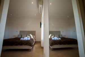 Postel nebo postele na pokoji v ubytování Residenza Lucio Alfio