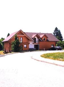 a house with a driveway in front of it at Vila Horček in Dolný Smokovec