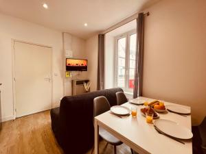a living room with a table and a dining room at L'Oasis - Home Homy in Carhaix-Plouguer +26 photos