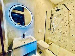 a bathroom with a sink and a shower and a mirror at Apartments Lungo Mare in Sveti Stefan