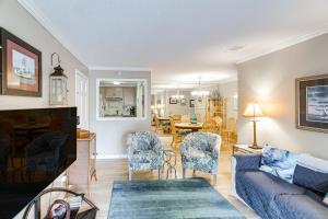 a living room with a couch and a dining room at St Simons Condo with Resort Amenities 1 Mi to Beach in Mallory Park