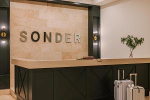 a hotel lobby with a sign that reads sander at Sonder Le Victoria in Montréal