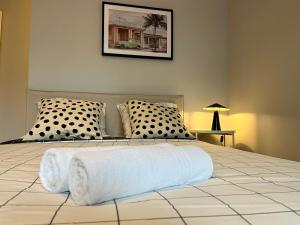 a bedroom with a large bed with two pillows at Suite Leeroy in Lyon