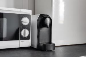 a toaster oven sitting next to a microwave at Sleepway Apartment - Marina in Poznań