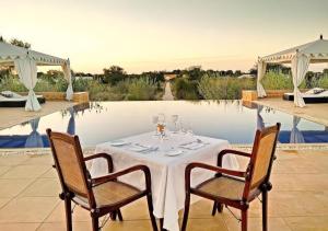 una mesa con copas de vino junto a una piscina en The Heritage Luxurious Camp en Jaisalmer