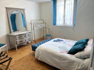 a bedroom with a bed and a dresser with a mirror at Villa B in La neuville roy