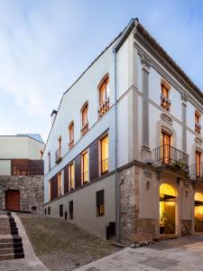 a large white building with windows and a staircase at Casa Marcial (adults only) in Besalú