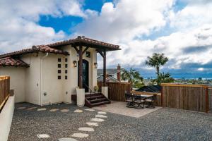 a small white house with a gate and a patio at Enchanting Encinitas Oceanview Casita in Encinitas