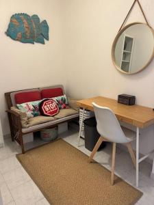 a room with a couch and a table and a mirror at Appartement en face mer in Six-Fours-les-Plages +26 photos
