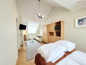 a bedroom with a bed and a living room at Apartamenty Cudowna Wyspa in Świnoujście